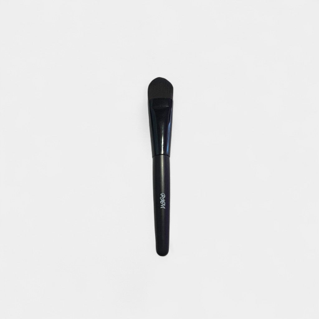 Black makeup brush on a gray background