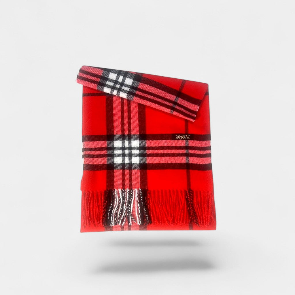 Red plaid scarf with black and white checkered pattern on a light gray background